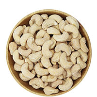 Wooden bowl filled with cream cheese and chives flavored cashews.